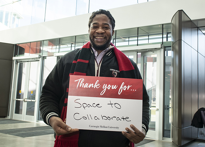 CMU Students Hold Sign Thanking Donors