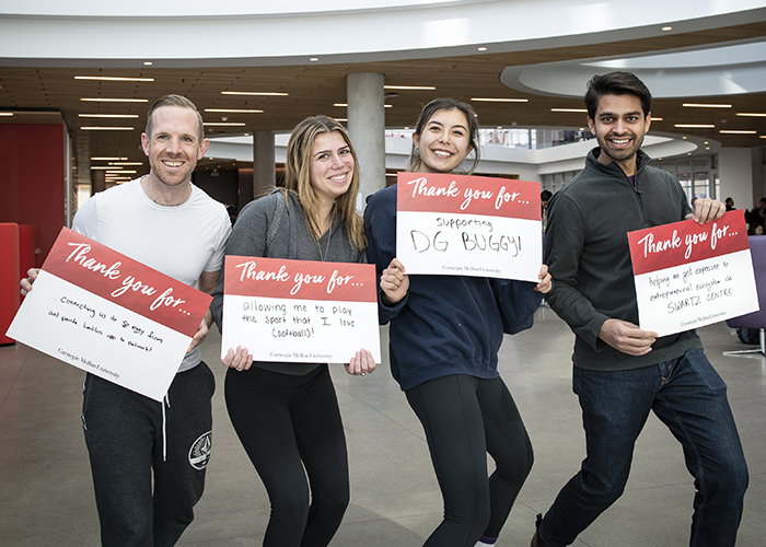 CMU Students Hold Sign Thanking Donors