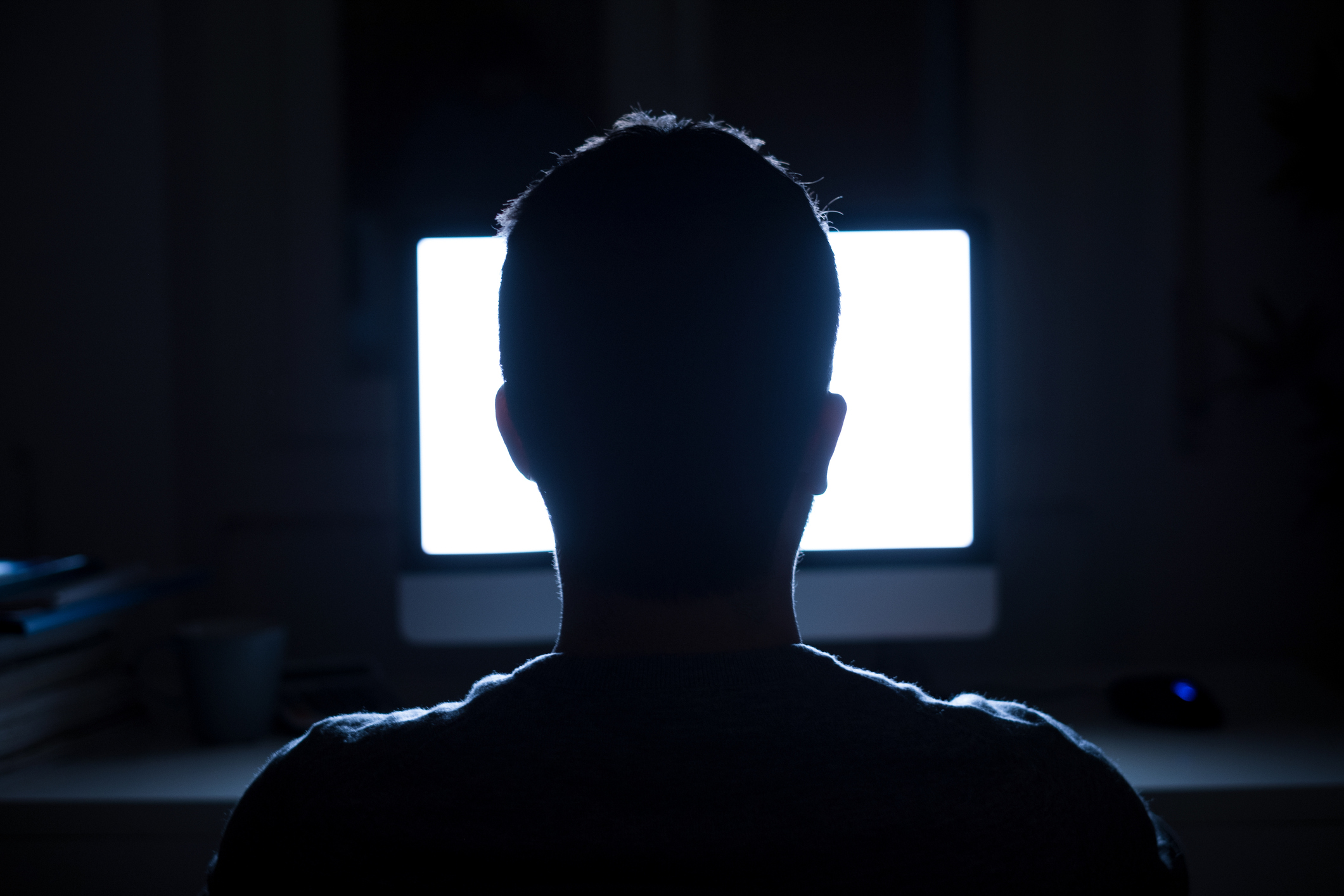 Man sits in front of computer