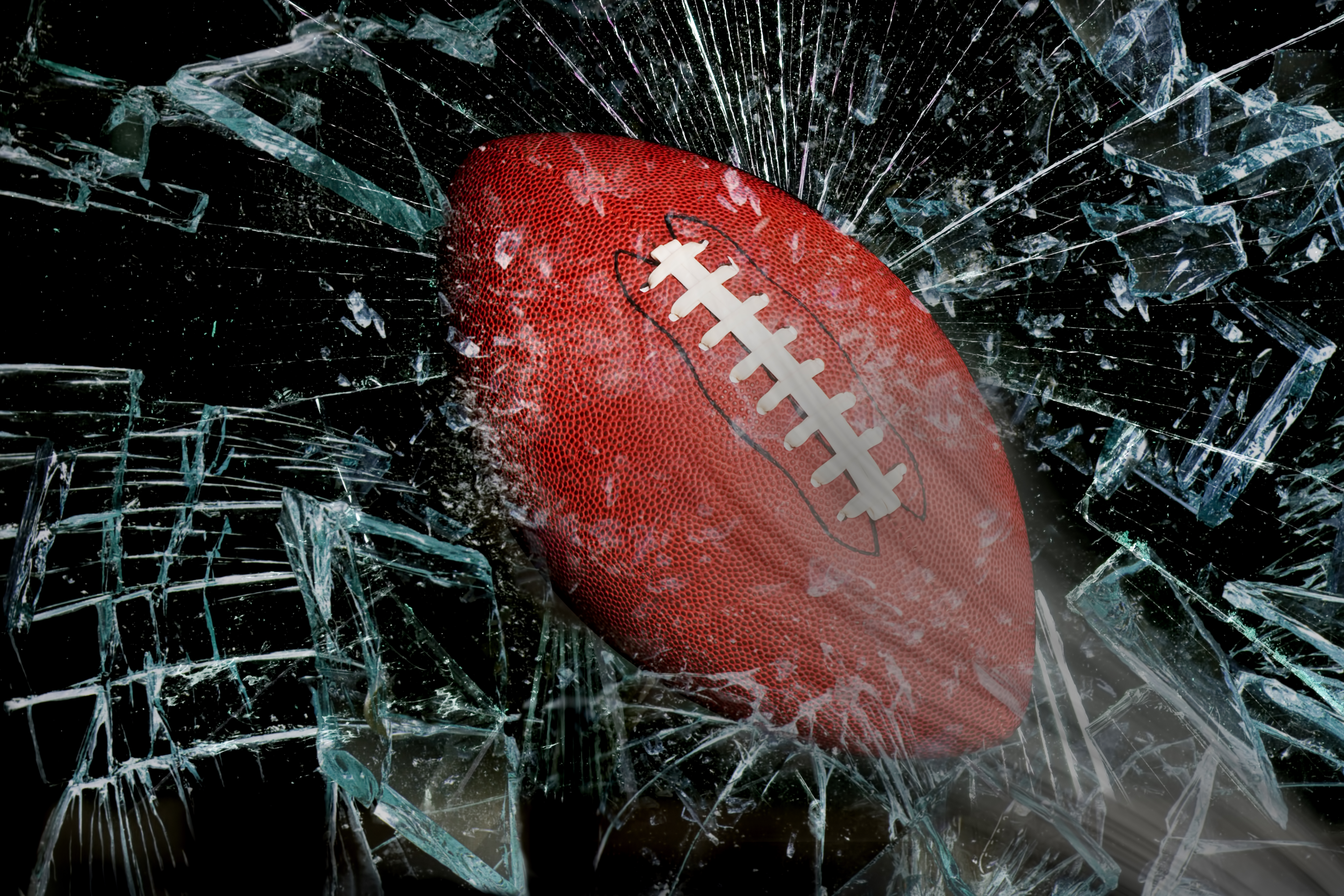 Football breaks through glass