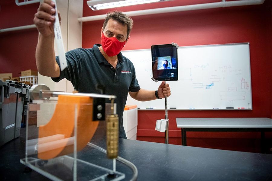 Faculty member using facetime for remote instruction in lab