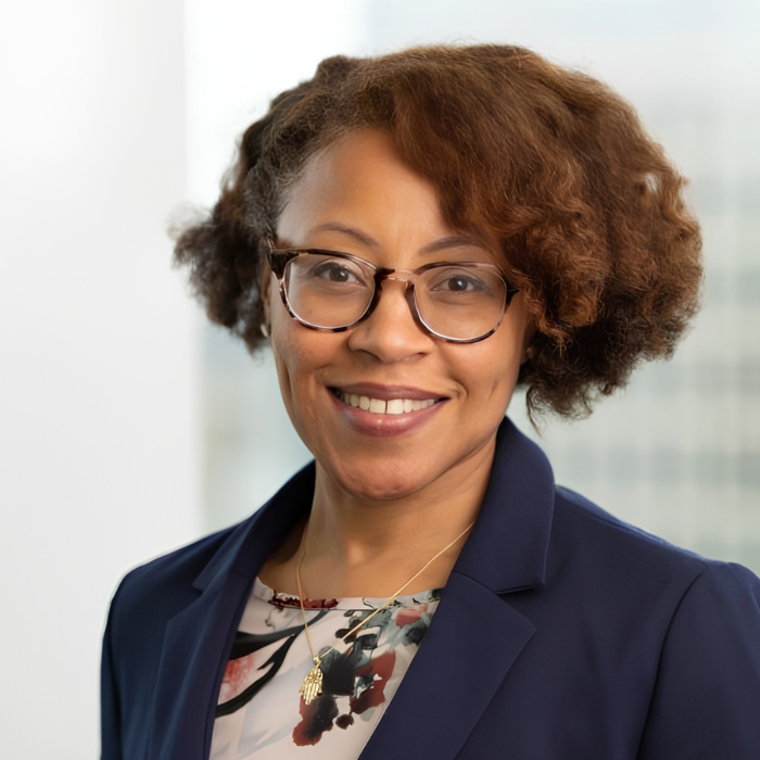Woman with glasses, floral blouse and navy blazer