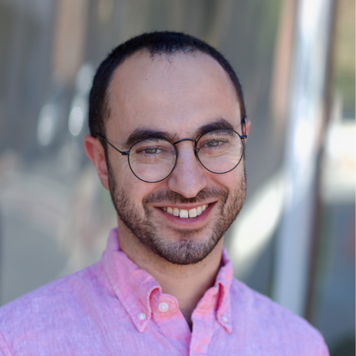 Man with glasses and pink dres shirt
