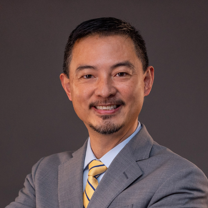 Man with short hair in light grey suit