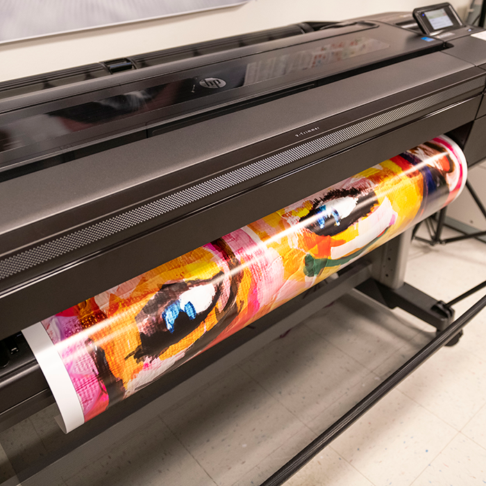 Large printer printing a colored poster