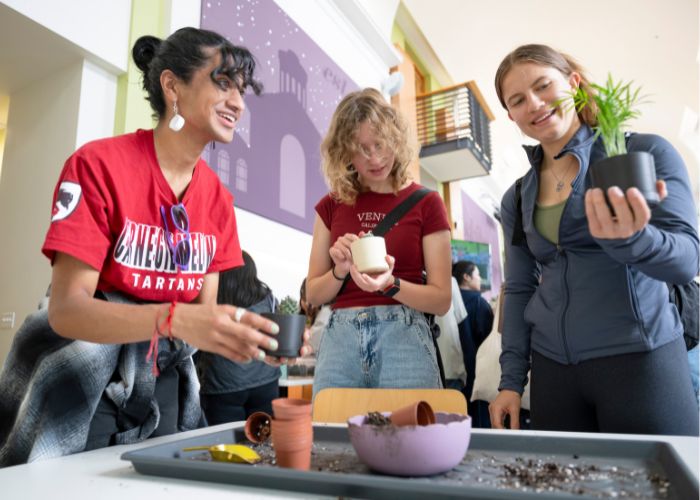 students potting plants together
