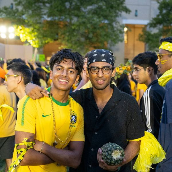 two students representing their house during the carnegie cup dressed in all yellow