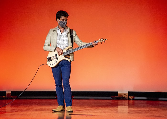 a student playing an electric guitar