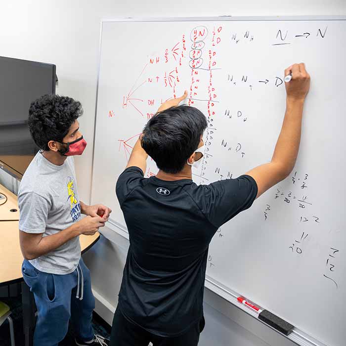 MCS students write on white board