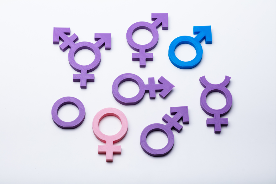 a series of gender symbols on a white background, including symbols for male, female, transgender.