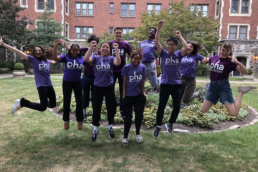 Peer Health Advocates where purple tshirts and jumping in the air