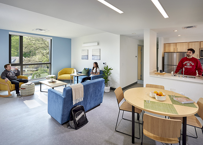 students hanging out in a common area of a forbes beeler apartment