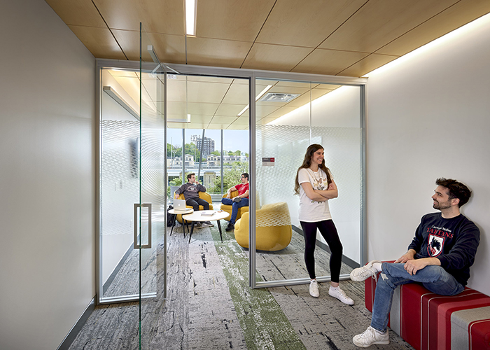 student inside and outside a forbes beeler study lounge with lots of natural light