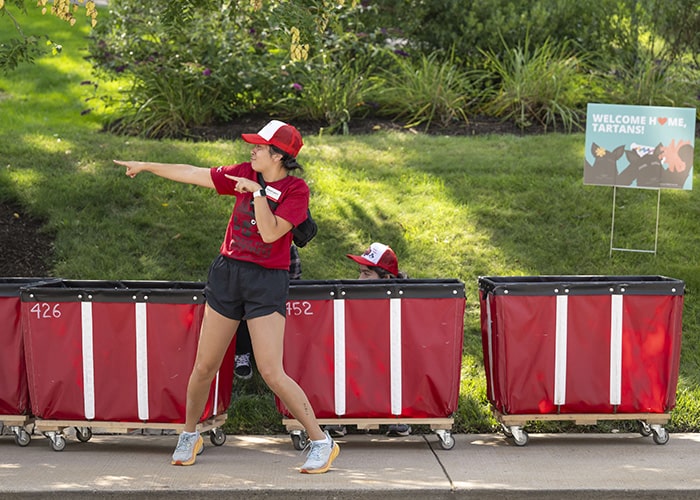 a student dressed in red having fun on Move In day