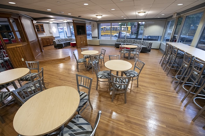 Residence on Fifth Apartments Common Space - lots of round tables and chairs bar seating and couches