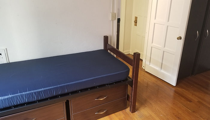Shirley Apartments Bedroom - bed with drawers underneath it
