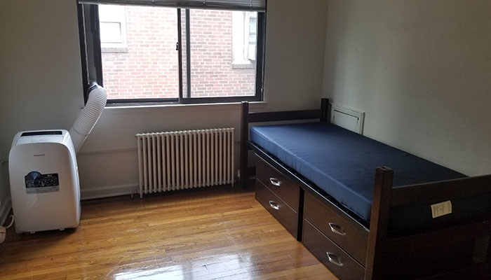 Shirley Apartments Bedroom - bed ac unit and windows