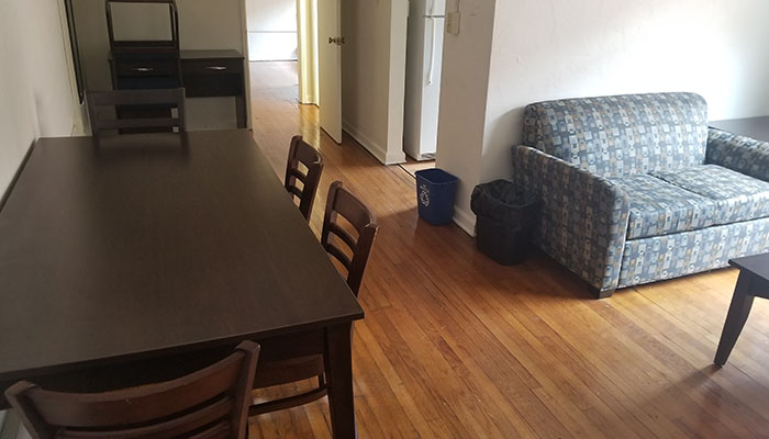 Shirley Apartments Living and Dining Room - a couch a dining table and look into the kitchen
