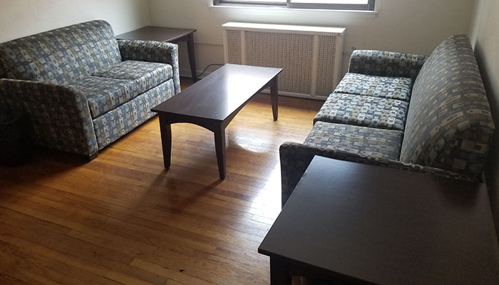 Shirley Apartments Living Room - two couches coffee tables and a window