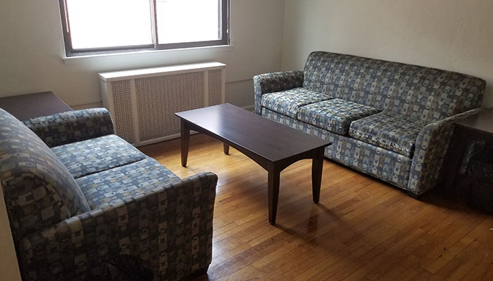 Shirley Apartments Living Room - two couches coffee tables and a window