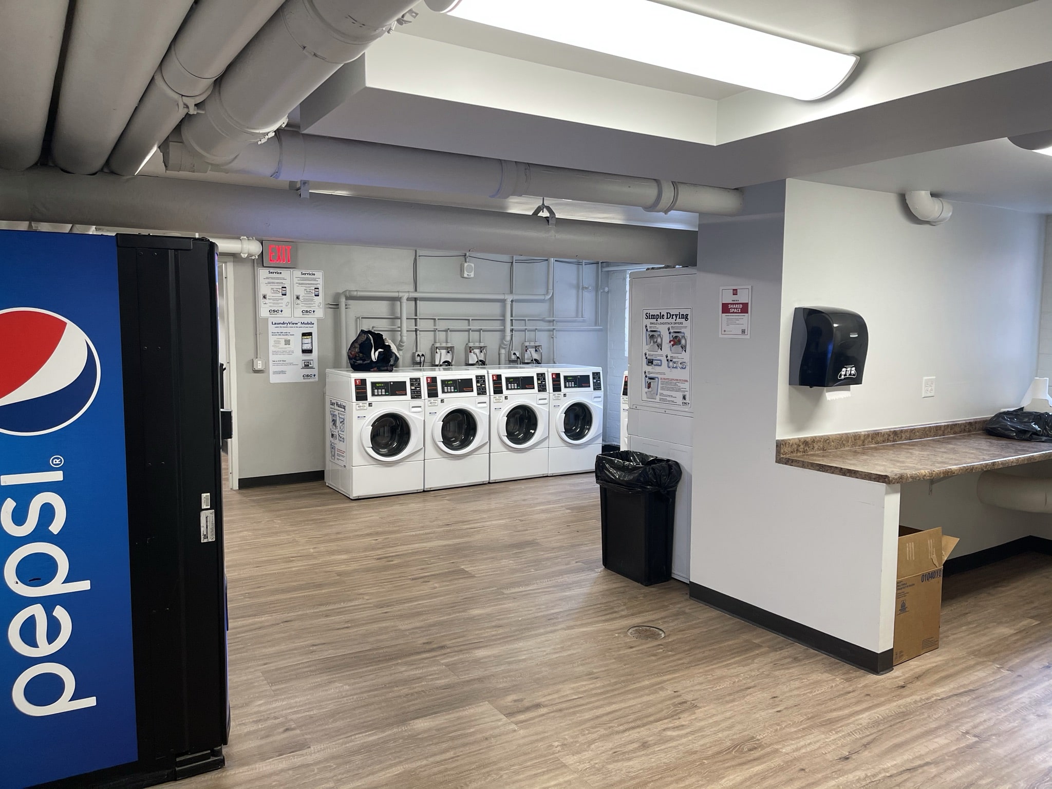 Fifth Neville Apartment Laundry - washers, dryer, folding area and vending machine