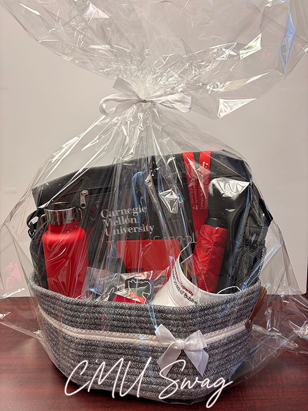 CMU Tepper swag raffle basket with a messenger bag, visor, umbrella and water bottle