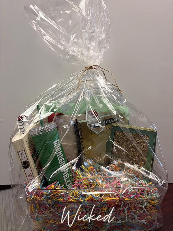 Wicked themed raffle basket with book and bookmark, water bottle, tote bag and notebook