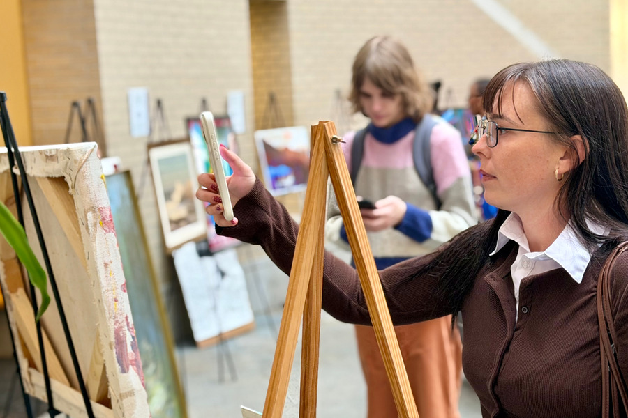 A staff member checks out the art show at the 2026 CMU Community Picnic