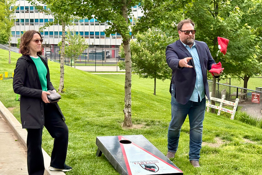 Peggy Jaafar (left) and Charlie Nash play cornhole at the 2026 CMU Community Picnic