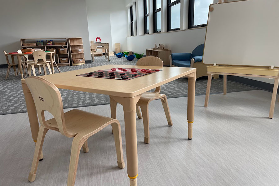 Table and chairs with checkers game setup in a classroom at the expanded Penn Avenue Cyert location