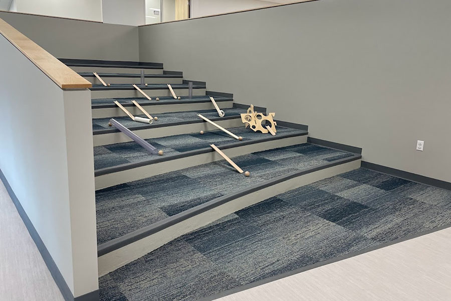 Carpeted stairs set up with physics toys at the expanded Penn Avenue Cyert location