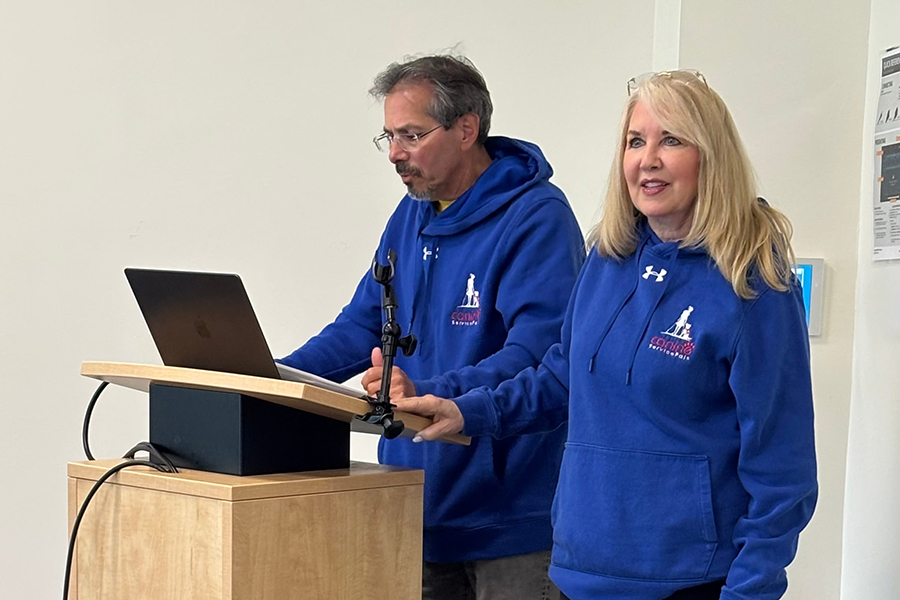 Two representatives from Canine Service Pals presenting at podium