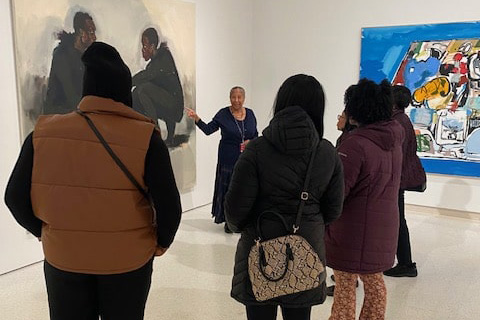 Sankofa members listening to tour guide at Carnegie Museum of Art