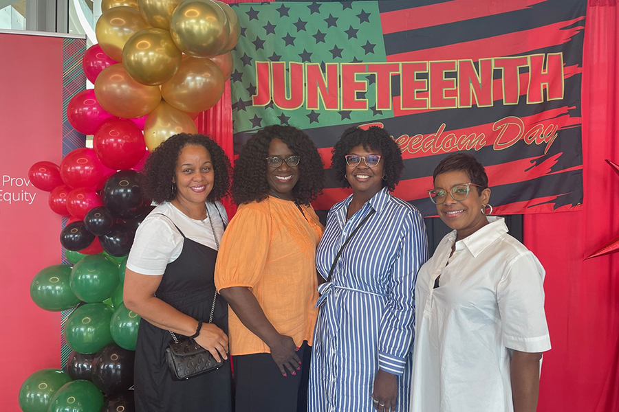 Attendees pose for a photo with Provost Garrett and President Jahanian during the Juneteenth reception