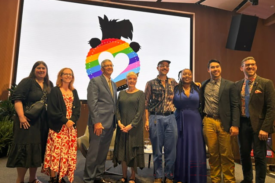 Group of attendees posing together at Pride Celebration