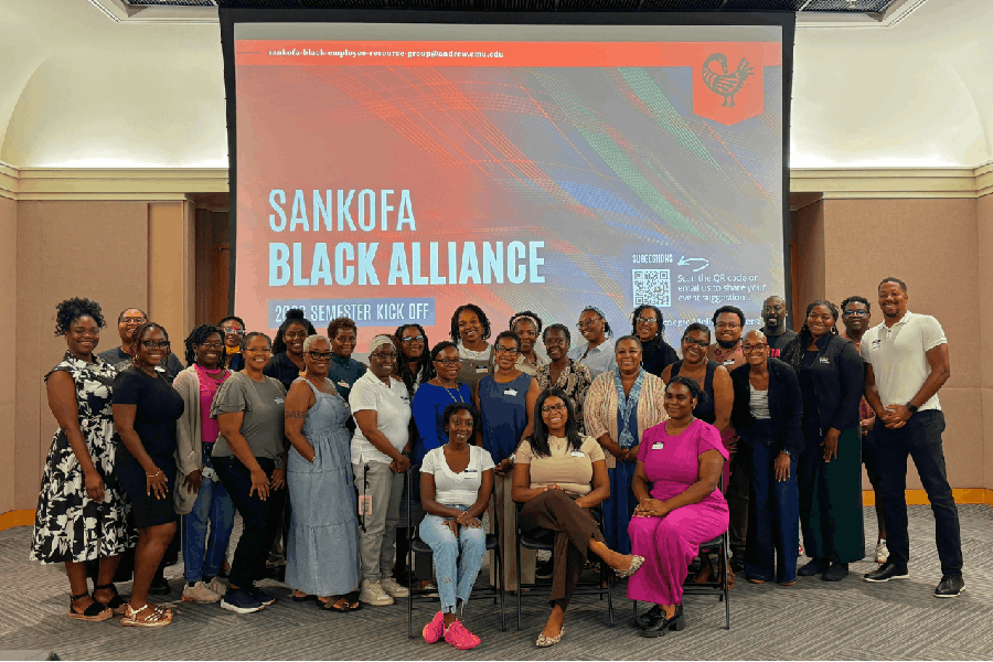Sankofa members posing in front of presentation screen