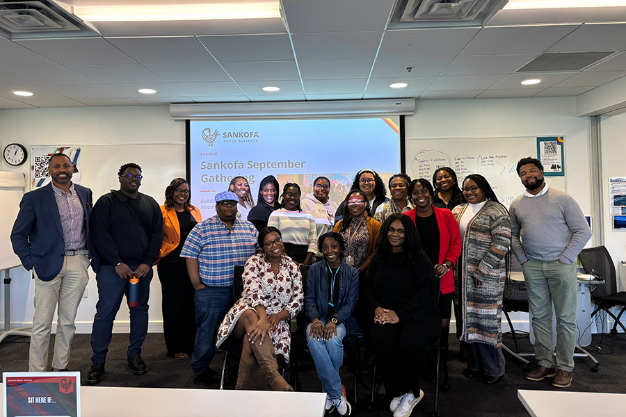 Sankofa members posing in front of presentation screen