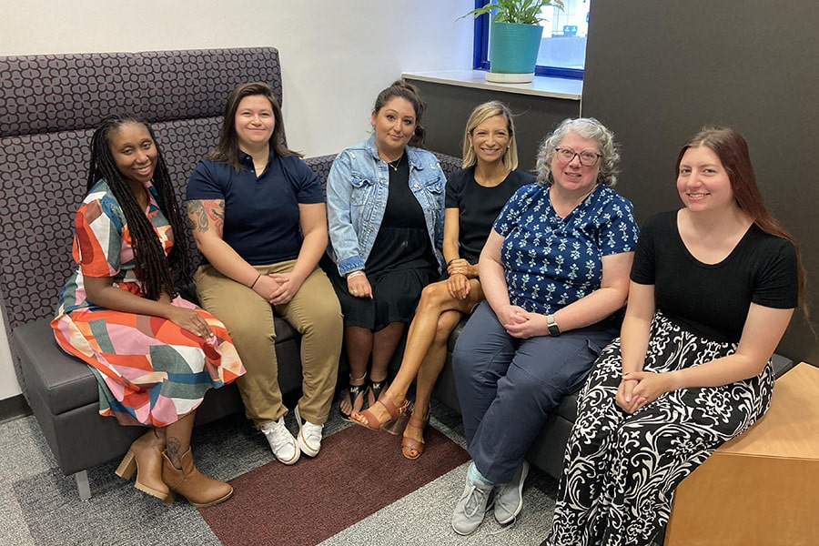 group picture of HR Faculty and Staff Services team's six members posing in the HR Service Center