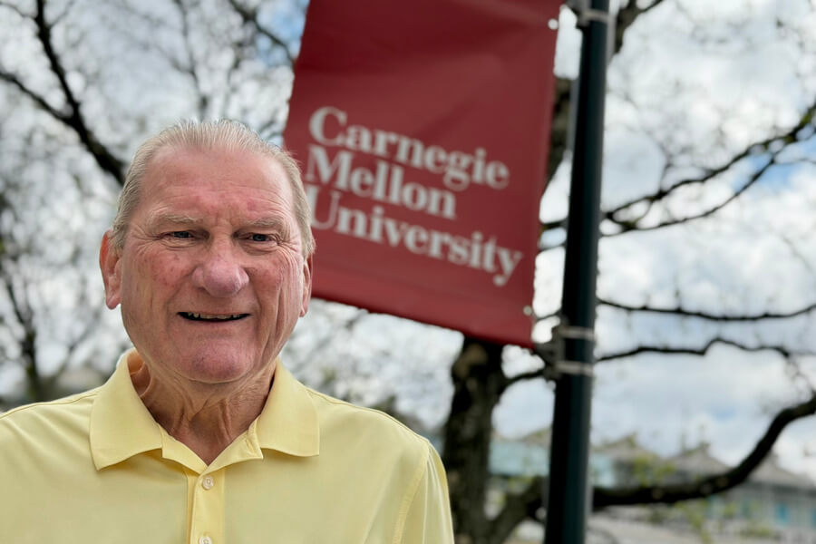 Jim Connelly poses near a CMU banner