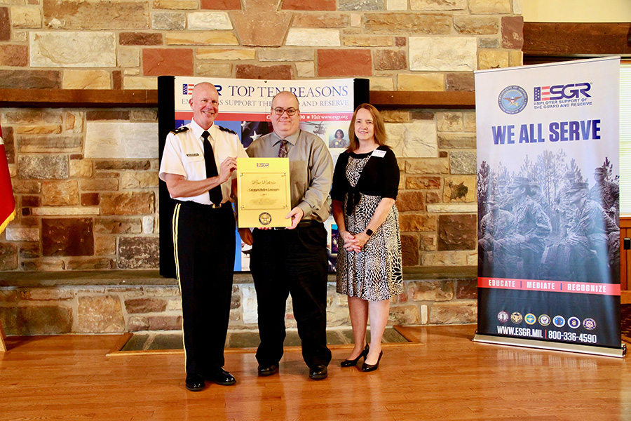 Todd Rosignoli, assistant vice president of Learning and Development, accepting Pro Patria award during ceremony