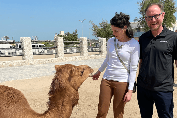 Heidi Bachner and Adam Marks pose with a camel