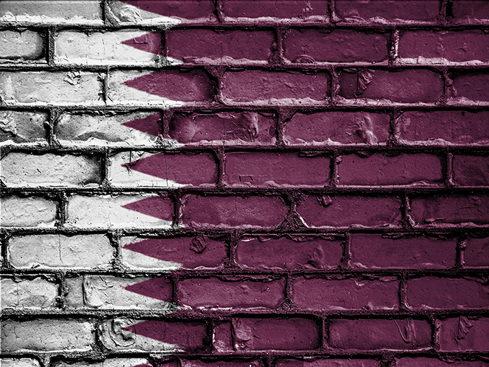 Qatar flag painted on brick background