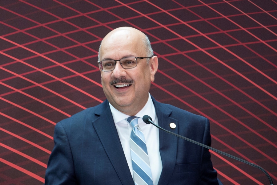 President Jahanian at podium with Tartan background