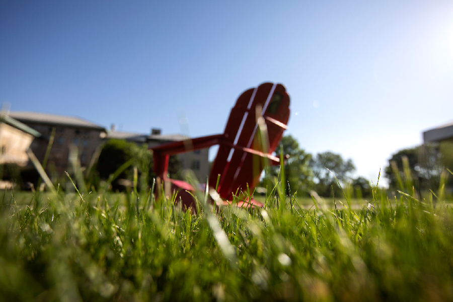 Red adirondack chair in the grass on The Cut