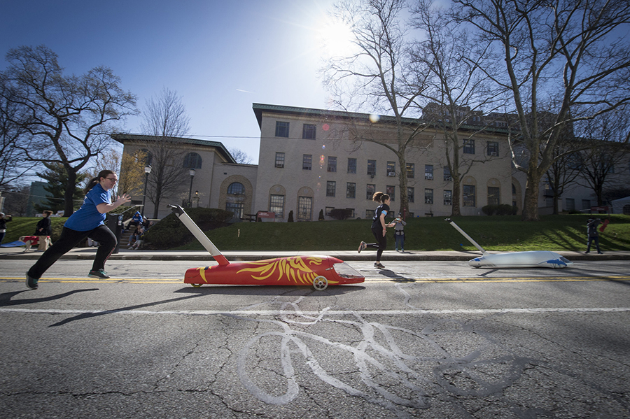 Students chase a buggy during Spring Carnival.