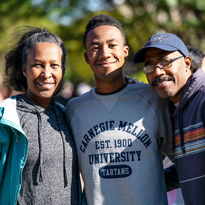 CMU student posing with parents