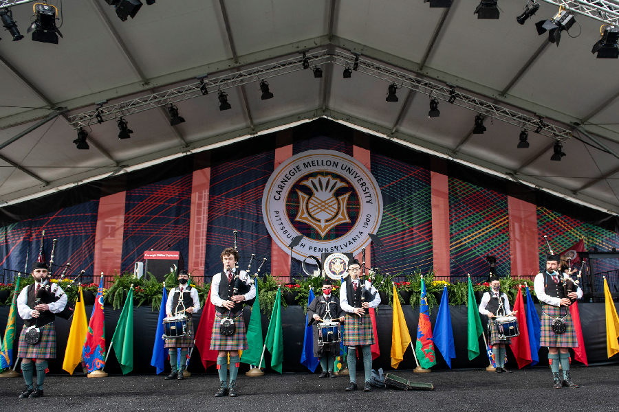Bagpipers performing on stage at graduation ceremony