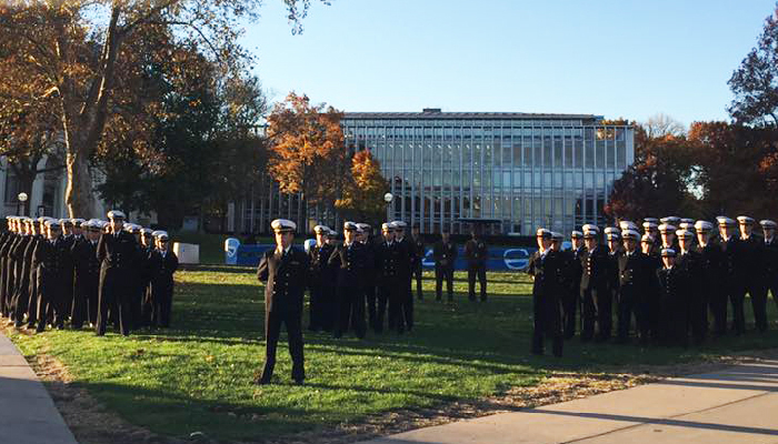 Veterans Day ceremony by the flag pole on the Campus Cut