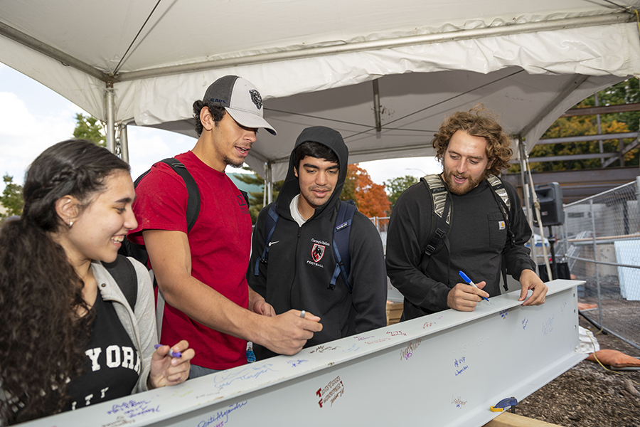 Students sign the beam for the HWAC building