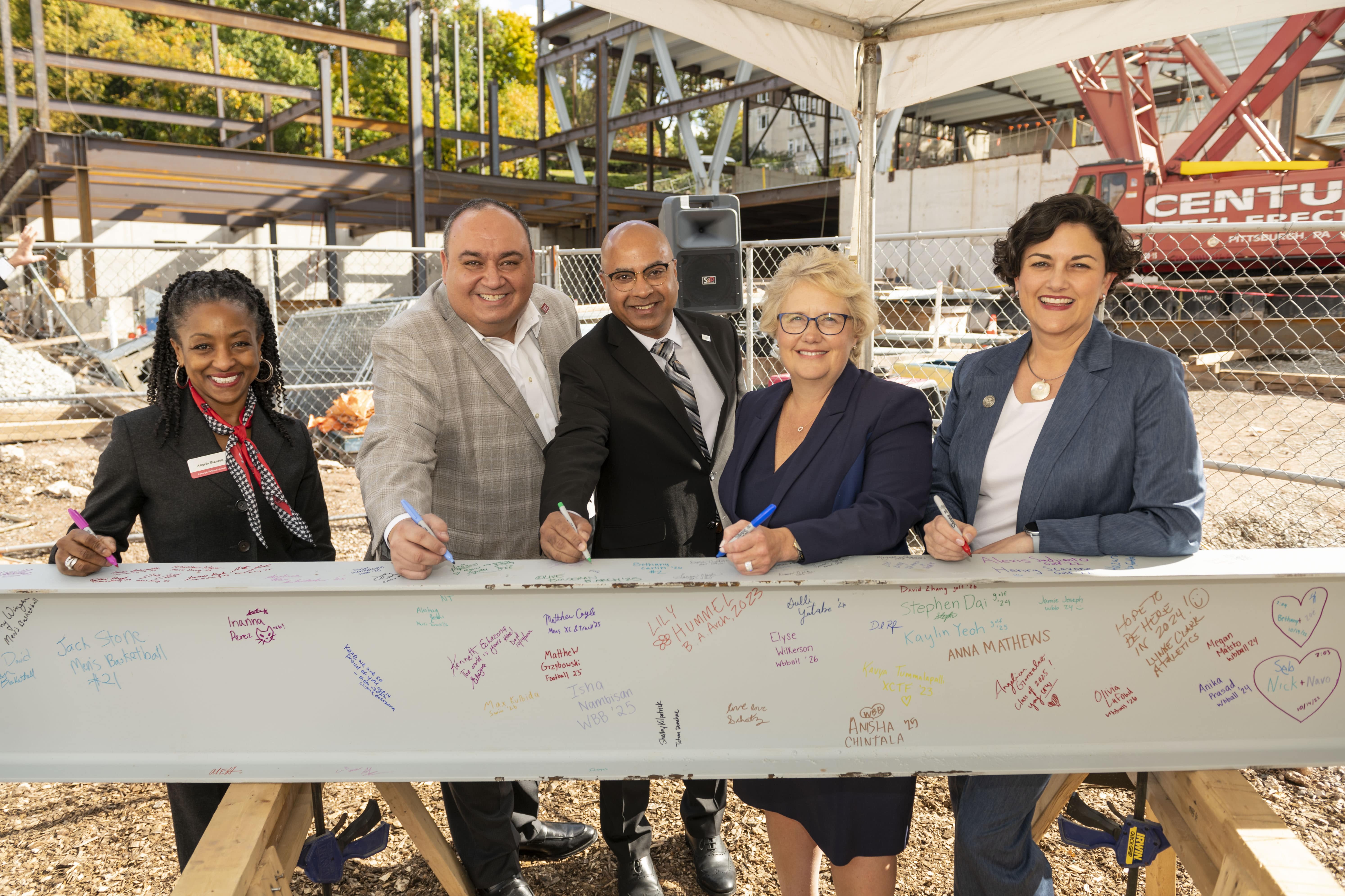 CMU leadership signs the beam